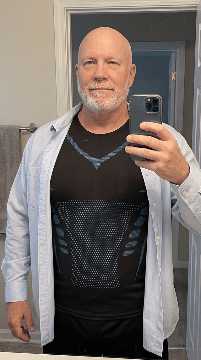 A man wearing the CoreLock tank under an open shirt