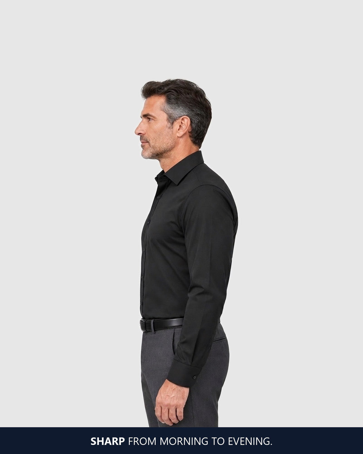 Side view of the black shirt falling straight from chest to belt